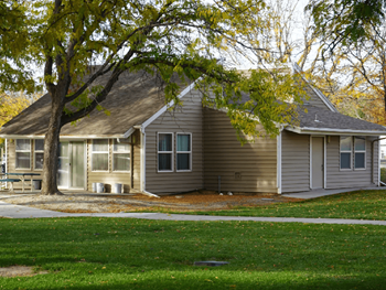 A house with a tree in front of it.